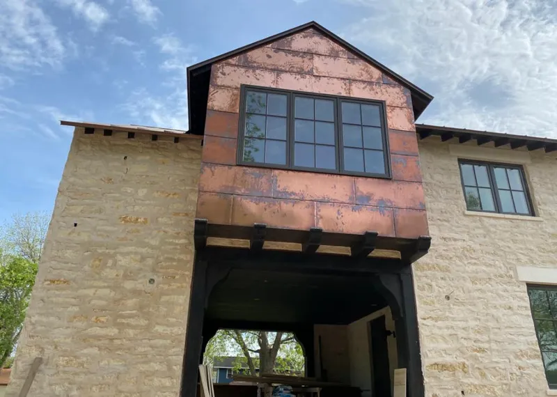 Copper metal panel facade on a stone building for Skylight Installation in Little Rock