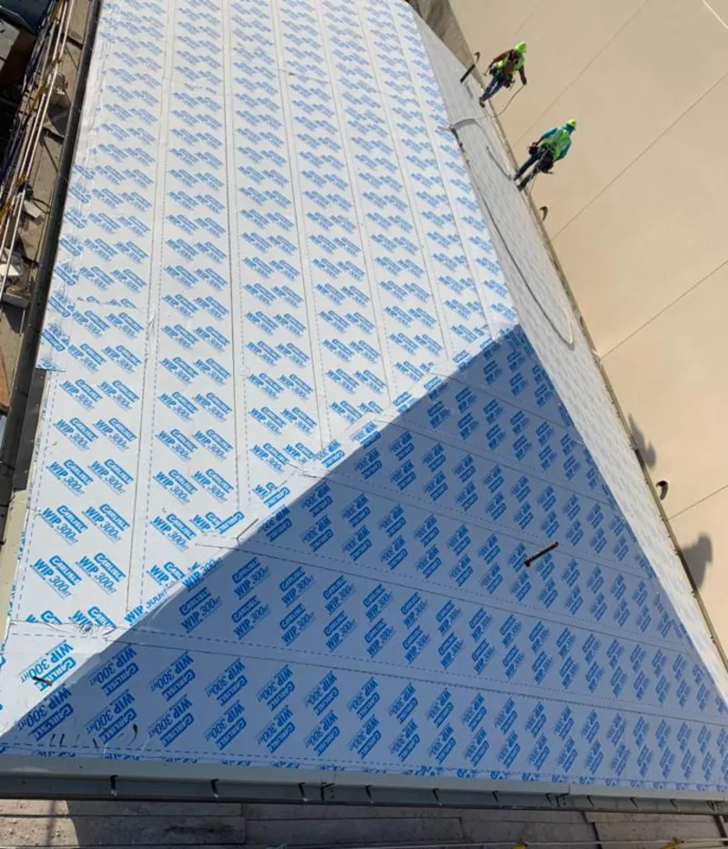 Professional roofers installing underlayment on a metal roof in Little Rock